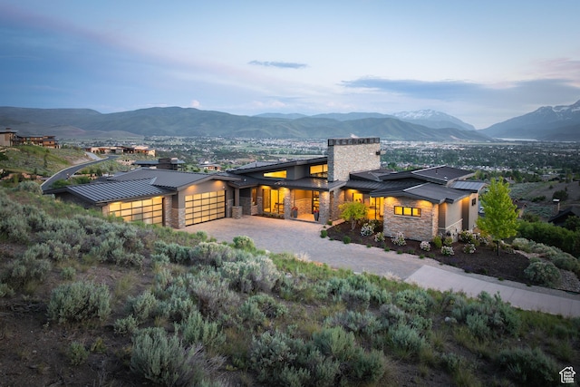 1703 N Chimney Rock Rd Unit 532, Heber City, UT 84032 - back of house featuring a standing seam roof, stone siding, and a mountain view