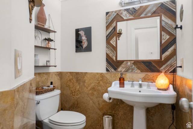 2692 S Grand Oak Cir E, Bountiful, UT 84010 - half bathroom with tile walls, toilet, and wainscoting