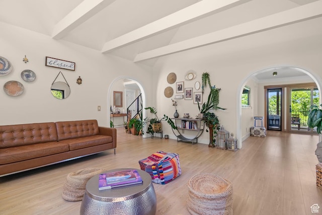 2692 S Grand Oak Cir E, Bountiful, UT 84010 - living room featuring arched walkways, wood finished floors, beamed ceiling, and baseboards