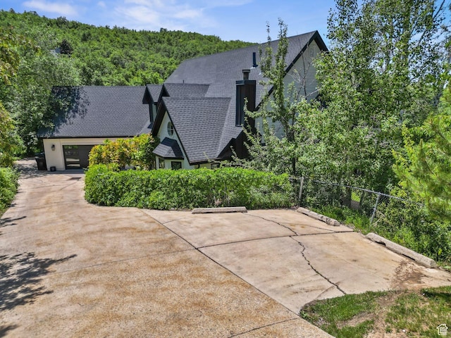 2692 S Grand Oak Cir E, Bountiful, UT 84010 - view of side of property with a shingled roof and a wooded view