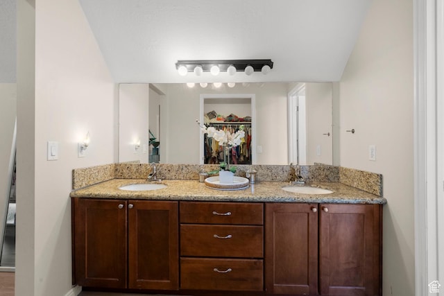2692 S Grand Oak Cir E, Bountiful, UT 84010 - full bathroom with double vanity, a spacious closet, and baseboards