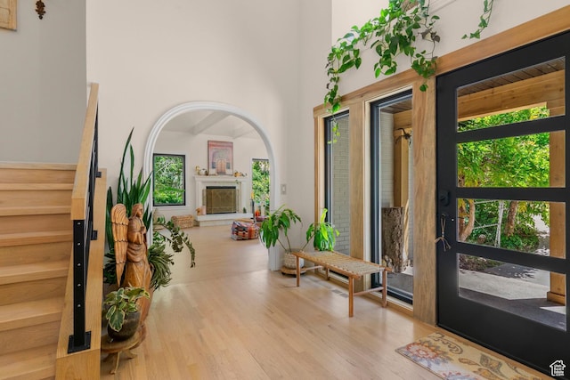 2692 S Grand Oak Cir E, Bountiful, UT 84010 - entryway with wood finished floors, a high ceiling, stairs, and a fireplace with raised hearth