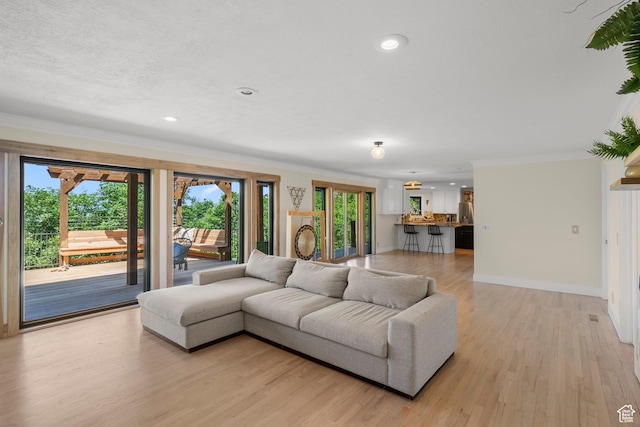 2692 S Grand Oak Cir E, Bountiful, UT 84010 - living area featuring healthy amount of natural light, ornamental molding, baseboards, light wood-style floors, and recessed lighting