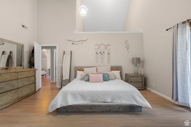 2692 S Grand Oak Cir E, Bountiful, UT 84010 - bedroom with a towering ceiling, wood finished floors, and baseboards