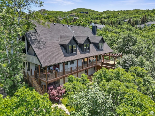 2692 S Grand Oak Cir E, Bountiful, UT 84010 - rear view of property with a chimney, roof with shingles, a wooden deck, and a wooded view
