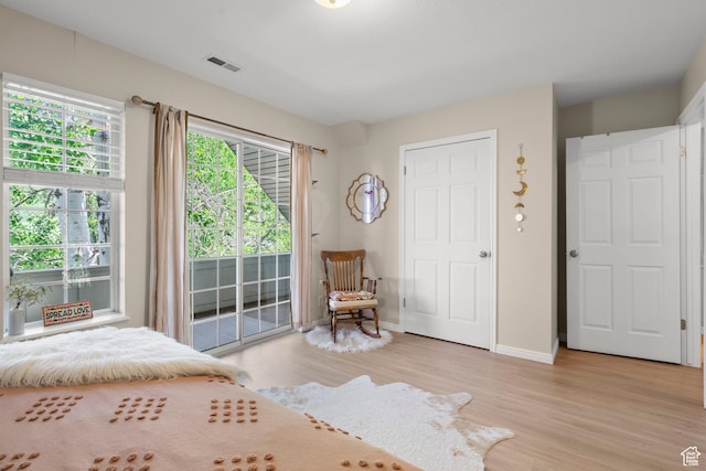 2692 S Grand Oak Cir E, Bountiful, UT 84010 - bedroom featuring access to outside, light wood-type flooring, and baseboards