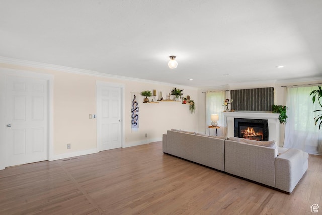 2692 S Grand Oak Cir E, Bountiful, UT 84010 - living area featuring a glass covered fireplace, ornamental molding, wood finished floors, baseboards, and recessed lighting