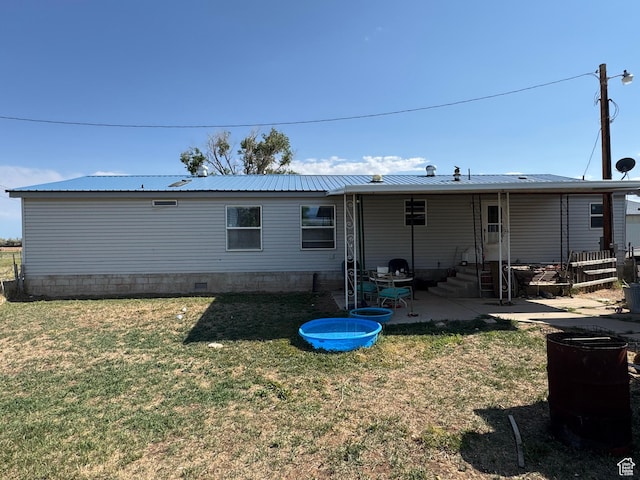 6153 E 2000 N, Roosevelt, UT 84066 - rear view of house featuring a yard, entry steps, a patio area, and metal roof