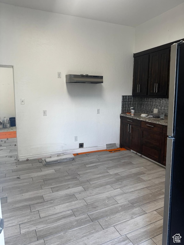188 E 100 N, Nephi, UT 84648 - kitchen featuring freestanding refrigerator, light wood-type flooring, backsplash, and dark brown cabinetry