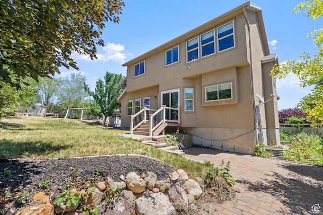 8002 S Overton Dr, West Jordan, UT 84081 - back of house featuring stucco siding and a patio