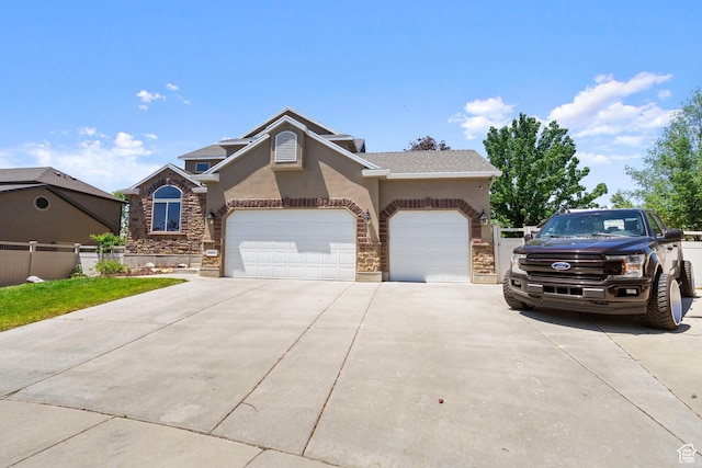 8002 S Overton Dr, West Jordan, UT 84081 - view of front of house featuring stucco siding, concrete driveway, a garage, and stone siding