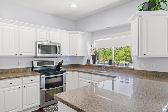 8002 S Overton Dr, West Jordan, UT 84081 - kitchen with stainless steel appliances, white cabinetry, recessed lighting, and a sink