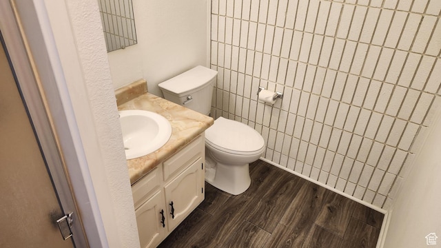 1896 W Homestead Farms Ln Unit 3, Salt Lake City, UT 84119 - half bathroom featuring vanity, toilet, and wood finished floors