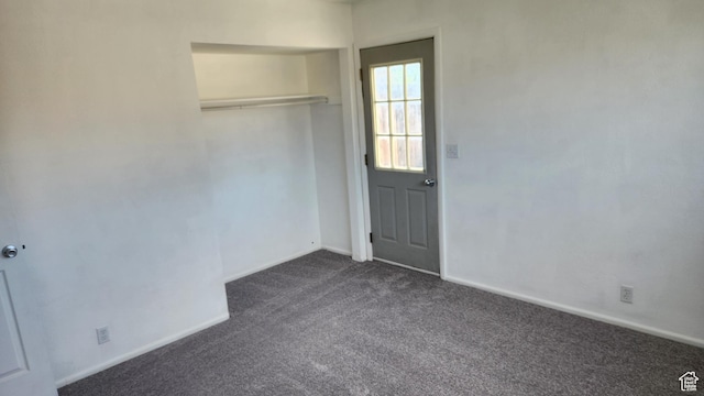 1896 W Homestead Farms Ln Unit 3, Salt Lake City, UT 84119 - unfurnished bedroom featuring dark carpet, baseboards, and a closet