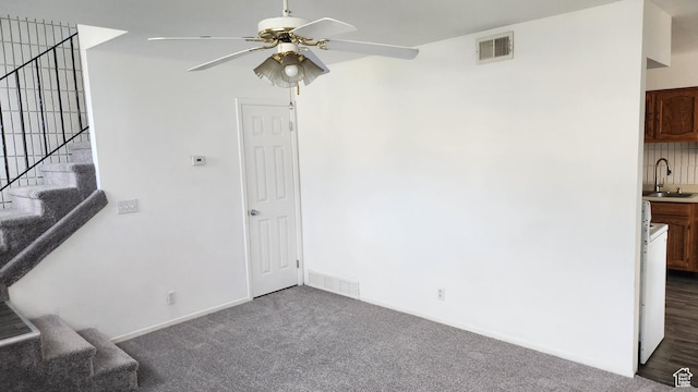 1896 W Homestead Farms Ln Unit 3, Salt Lake City, UT 84119 - unfurnished living room with ceiling fan, a sink, dark carpet, stairway, and baseboards