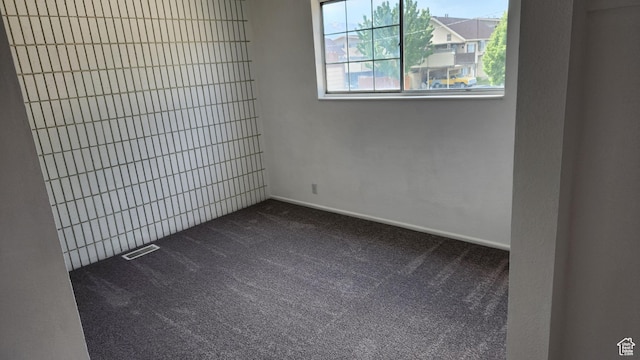 1896 W Homestead Farms Ln Unit 3, Salt Lake City, UT 84119 - spare room with dark carpet and baseboards