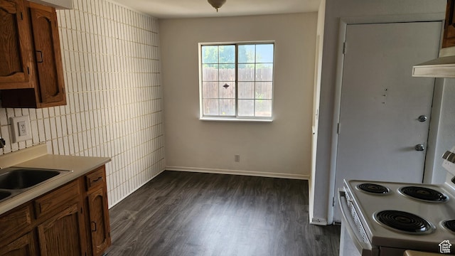 1896 W Homestead Farms Ln Unit 3, Salt Lake City, UT 84119 - kitchen featuring white electric range, dark wood-type flooring, brown cabinetry, light countertops, and tile walls