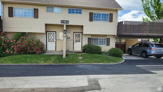 1896 W Homestead Farms Ln Unit 3, Salt Lake City, UT 84119 - view of property with brick siding and roof with shingles