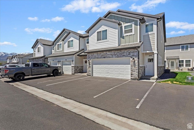 290 N 100 W, Morgan, UT 84050 - townhome / multi-family property featuring board and batten siding, stone siding, a garage, a residential view, and asphalt driveway