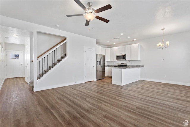 290 N 100 W, Morgan, UT 84050 - kitchen featuring appliances with stainless steel finishes, open floor plan, a chandelier, a peninsula, and recessed lighting