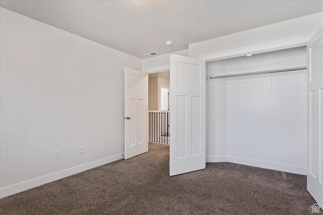 290 N 100 W, Morgan, UT 84050 - unfurnished bedroom featuring dark carpet, baseboards, and a closet