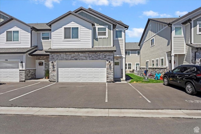 290 N 100 W, Morgan, UT 84050 - townhome / multi-family property featuring board and batten siding, stone siding, an attached garage, and asphalt driveway
