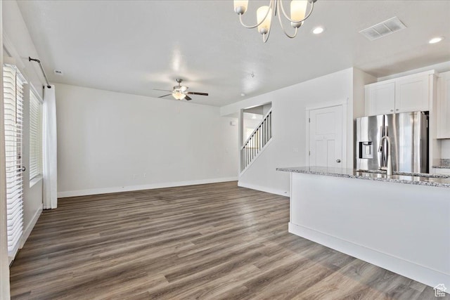 290 N 100 W, Morgan, UT 84050 - unfurnished living room with a ceiling fan, dark wood-type flooring, stairs, baseboards, and a chandelier