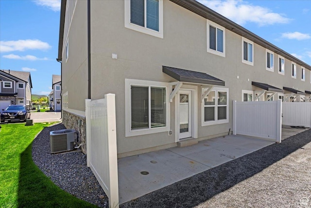 290 N 100 W, Morgan, UT 84050 - back of house featuring central AC, a patio area, and stucco siding