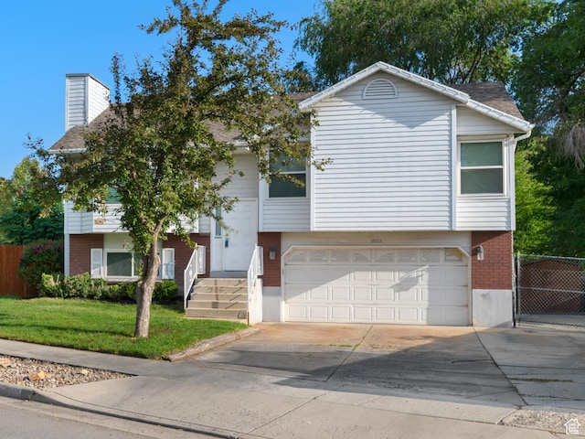 1022 E Lafayette St S, Sandy, UT 84094 - view of front of home featuring brick siding, driveway, a chimney, and a garage