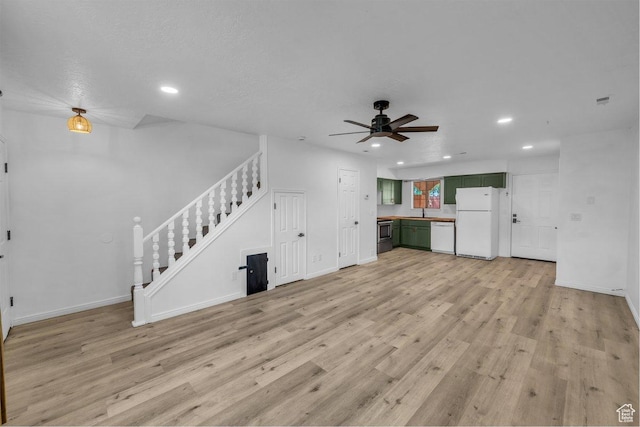 2158 W 70 S, Hurricane, UT 84737 - unfurnished living room featuring a ceiling fan, recessed lighting, stairway, light wood-style flooring, and baseboards