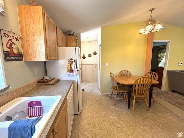 380 Portal Vista Loop, Moab, UT 84532 - kitchen featuring a chandelier, decorative light fixtures, light floors, a sink, and vaulted ceiling