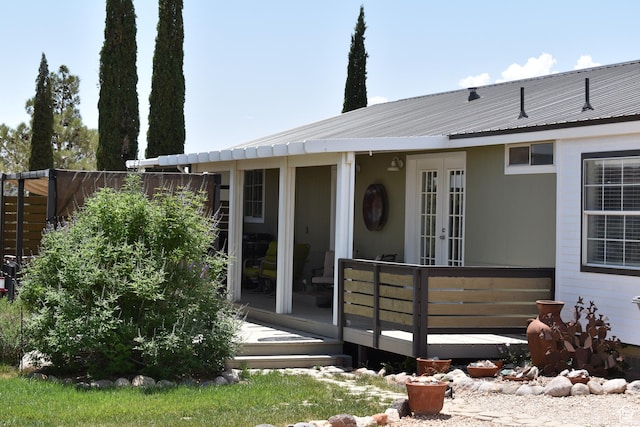 527 S Moenkopi Dr, Leeds, UT 84746 - view of front facade featuring french doors, a deck, and metal roof