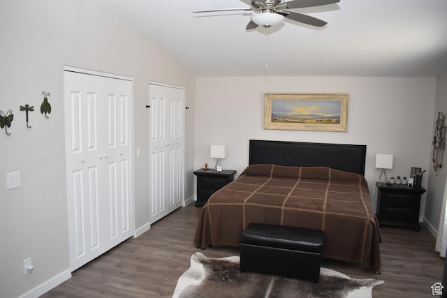 527 S Moenkopi Dr, Leeds, UT 84746 - bedroom featuring two closets, wood finished floors, baseboards, vaulted ceiling, and a ceiling fan