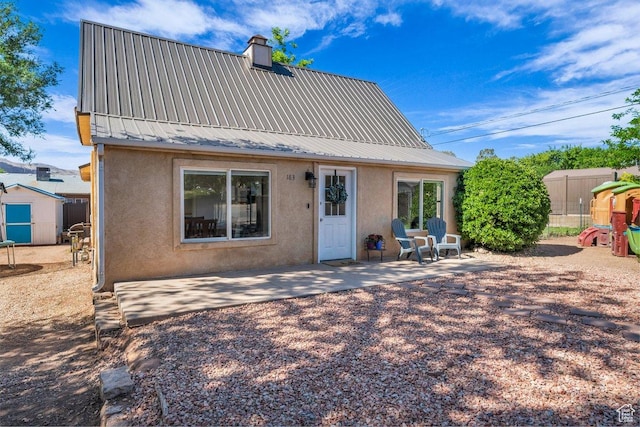 183 W 200 N, Hurricane, UT 84737 - rear view of property with stucco siding, a patio, metal roof, and a chimney
