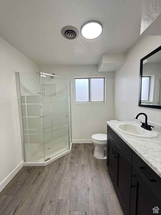 1698 Kenilworth Rd, Helper, UT 84526 - full bath featuring a shower stall, vanity, toilet, wood finished floors, and baseboards