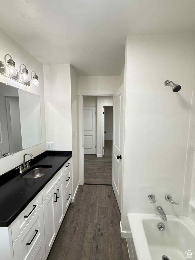 1698 Kenilworth Rd, Helper, UT 84526 - bathroom with wood finished floors, vanity, bathtub / shower combination, and baseboards