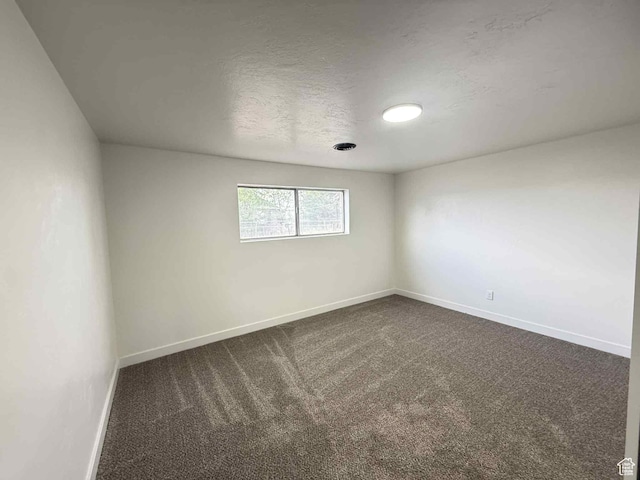 1698 Kenilworth Rd, Helper, UT 84526 - spare room with baseboards and dark colored carpet
