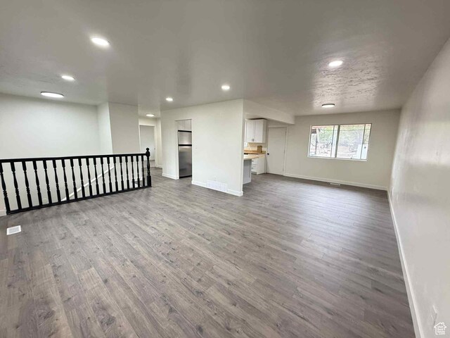 1698 Kenilworth Rd, Helper, UT 84526 - unfurnished living room with wood finished floors, baseboards, and recessed lighting