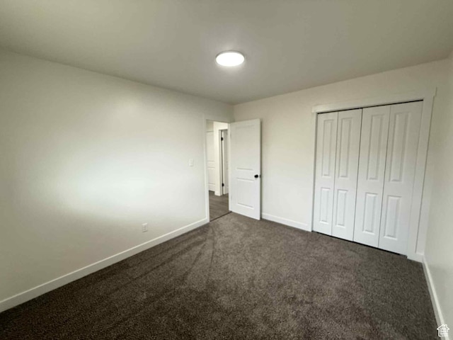1698 Kenilworth Rd, Helper, UT 84526 - unfurnished bedroom with baseboards, dark carpet, and a closet