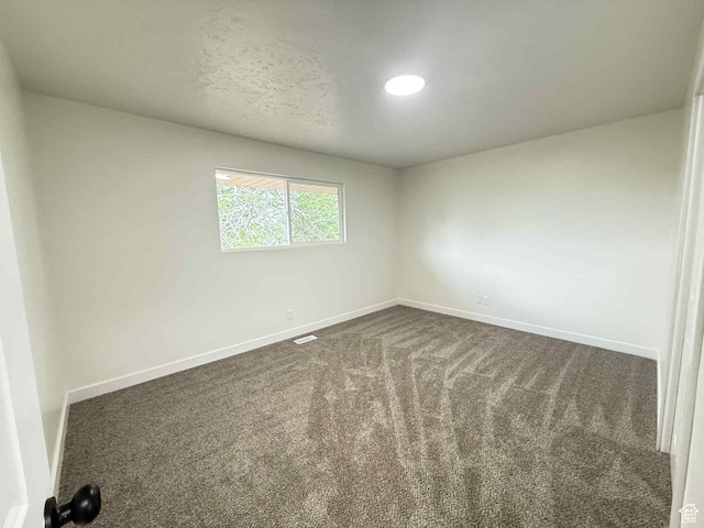 1698 Kenilworth Rd, Helper, UT 84526 - spare room with baseboards and dark colored carpet