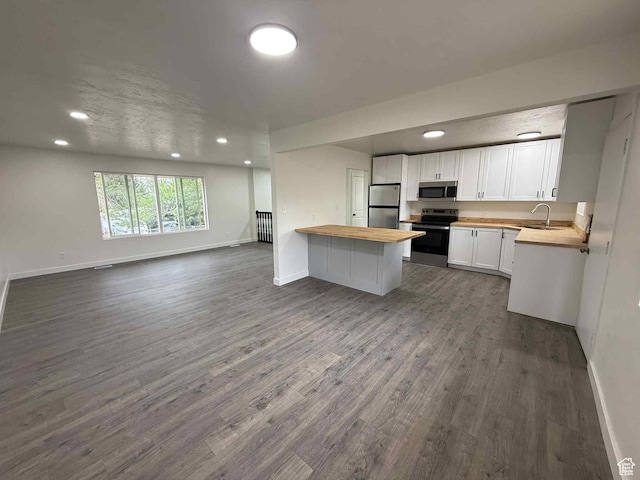 1698 Kenilworth Rd, Helper, UT 84526 - kitchen with appliances with stainless steel finishes, wooden counters, open floor plan, baseboards, and dark wood finished floors