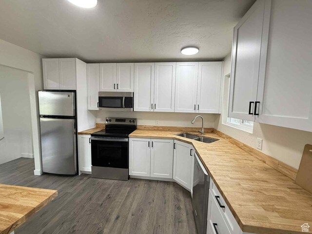 1698 Kenilworth Rd, Helper, UT 84526 - kitchen with stainless steel appliances, a sink, dark wood-style floors, and white cabinetry