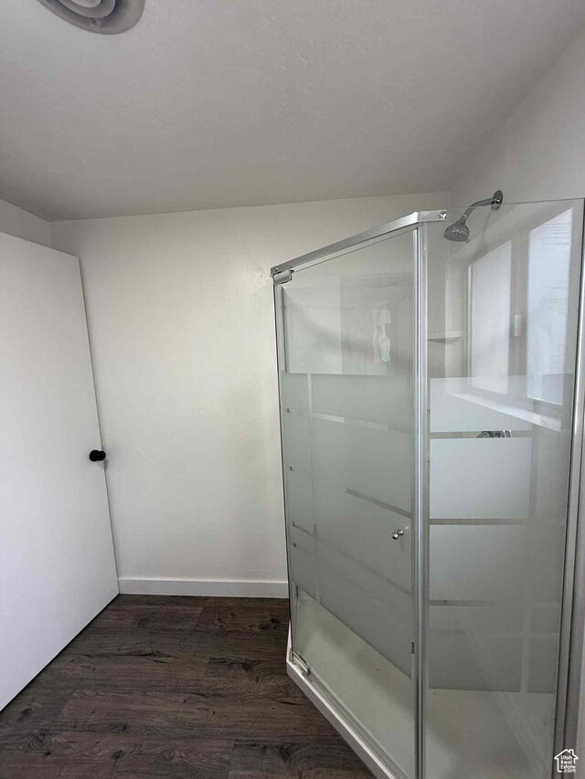 1698 Kenilworth Rd, Helper, UT 84526 - bathroom with a stall shower, wood finished floors, and baseboards
