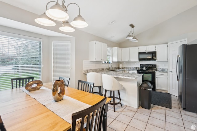 910 W Brandermill Cv, Murray, UT 84123 - dining space featuring vaulted ceiling and light tile patterned floors
