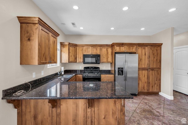 40 W Pecan Ln, Leeds, UT 84746 - kitchen with black appliances, a sink, a peninsula, brown cabinets, and dark stone counters