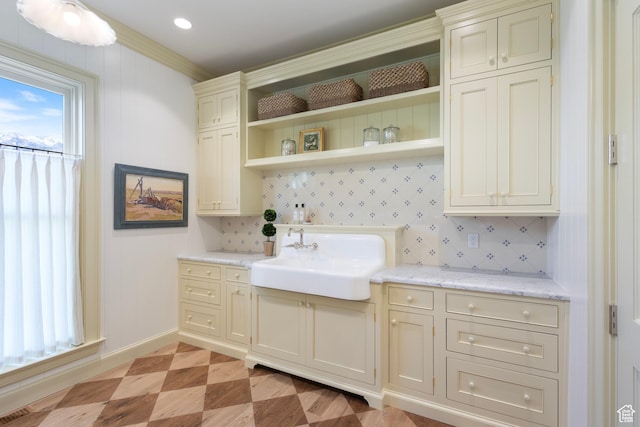 1449 Annie Cir N, Alpine, UT 84004 - kitchen featuring a sink, open shelves, baseboards, light stone countertops, and cream cabinets