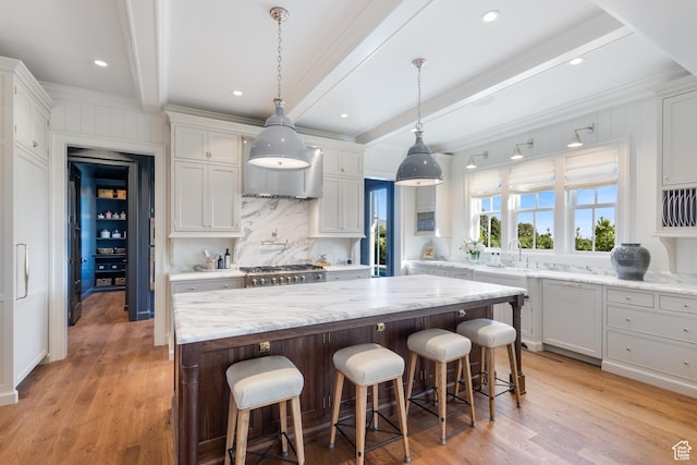 1449 Annie Cir N, Alpine, UT 84004 - kitchen with beamed ceiling, decorative backsplash, a kitchen island, light wood-style flooring, and white cabinets