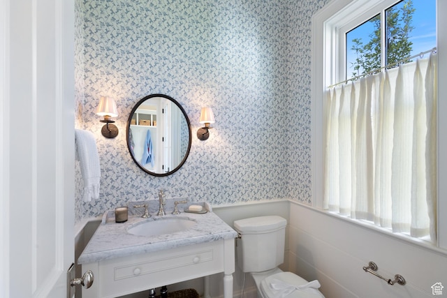 1449 Annie Cir N, Alpine, UT 84004 - bathroom featuring wallpapered walls, toilet, vanity, and a wainscoted wall
