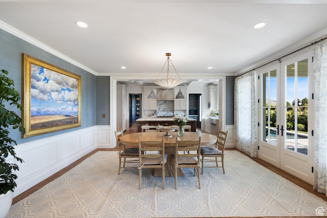 1449 Annie Cir N, Alpine, UT 84004 - dining space with crown molding, light wood-type flooring, a decorative wall, wainscoting, and recessed lighting