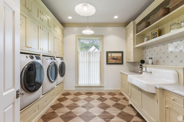 1449 Annie Cir N, Alpine, UT 84004 - laundry area featuring washing machine and clothes dryer, cabinet space, baseboards, light floors, and ornamental molding